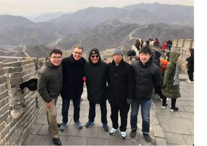 Team Cabot celebrates a successful business sale with a memorable group photo atop the Great Wall.